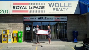 Mark Wolle, Broker of Record, Royal Le Page Wolle Realty, presents a donation cheque to Alan Sharpe of Women's Crisis Services for $10,091 in support of Anselma House.