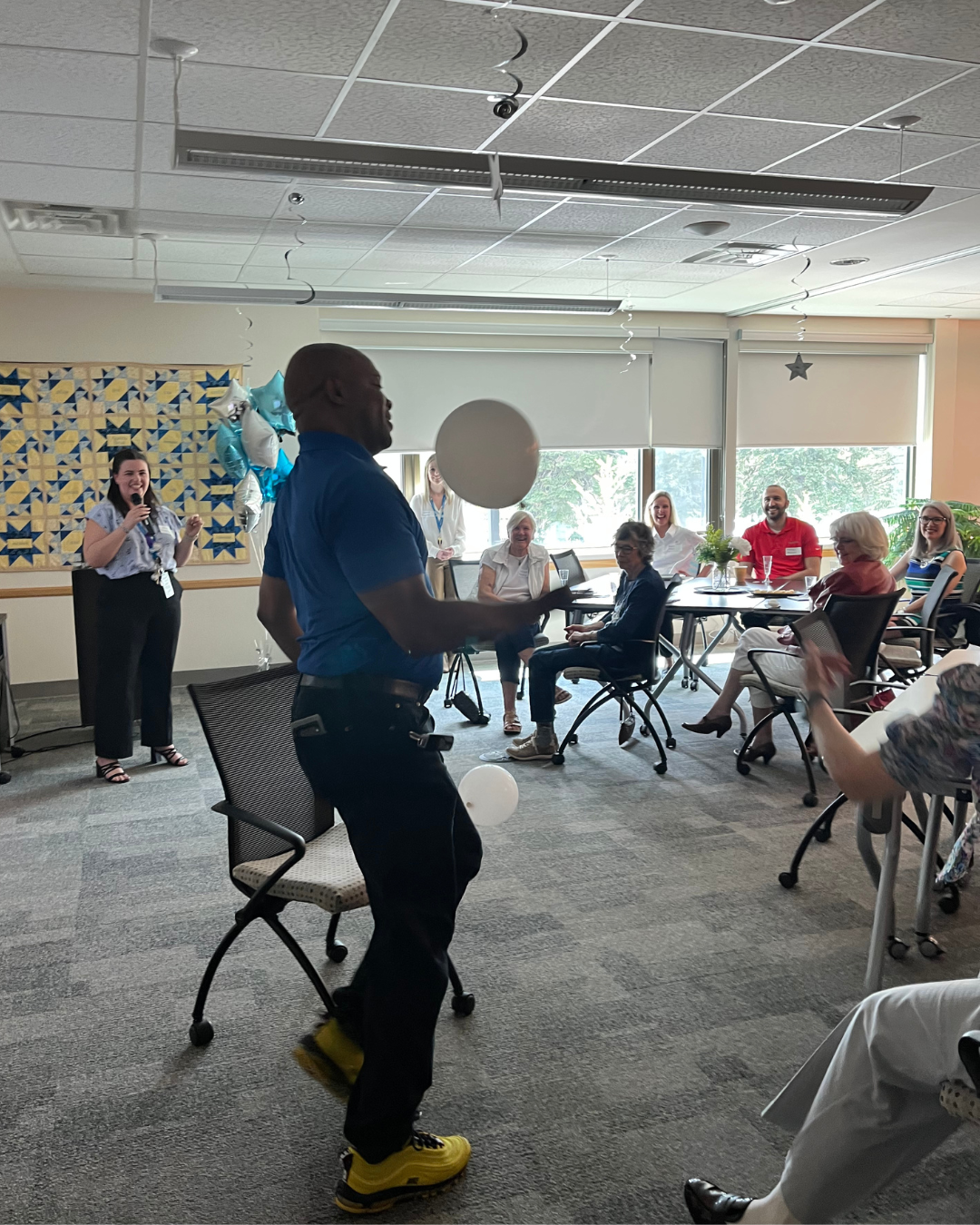 Picture showcasing the backs of three young men. One has their arm around the other to show support and caring behaviour.